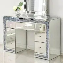 a silver vanity with a mirror on top of it